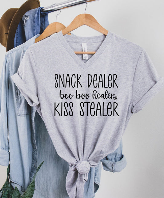 Snack Dealer Boo Boo Healer Kiss Stealer, Funny Mom Shirt, Preschool Mom, Mother's Day Shirt, Unisex V Neck Graphic Tee T-Shirt