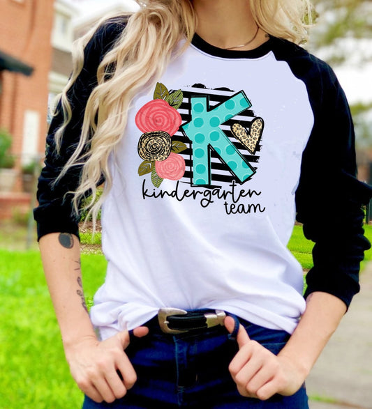 Kinder Team Back To School Kindergarten Teacher Floral Novelty Graphic Unisex Raglan Shirt